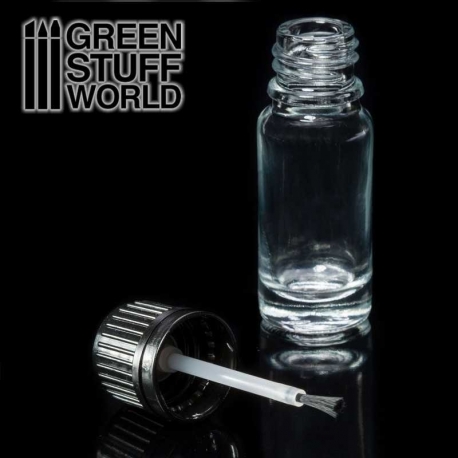 Empty glass jar with paintbrush